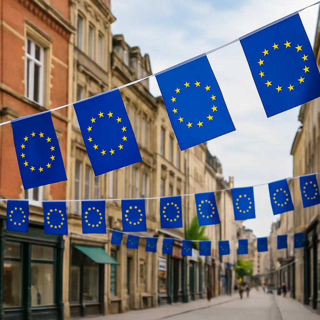 European Union bunting – 6 metre string of square blue flags with yellow stars, hanging across a traditional European high street