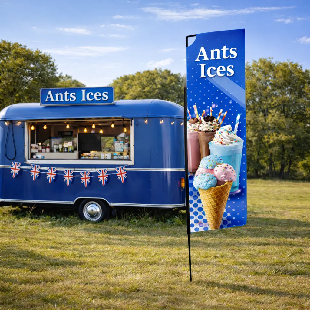 Event Banner Flag in a field next to a trailer