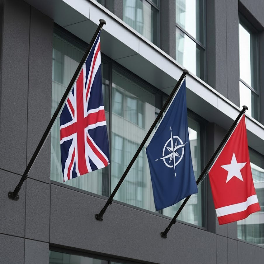 Black flagpoles wall mounted on a modern building