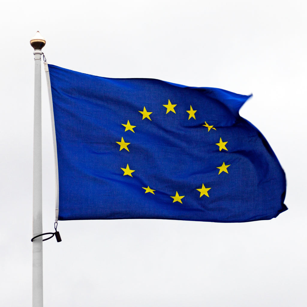 European Union flag waving on a white background
