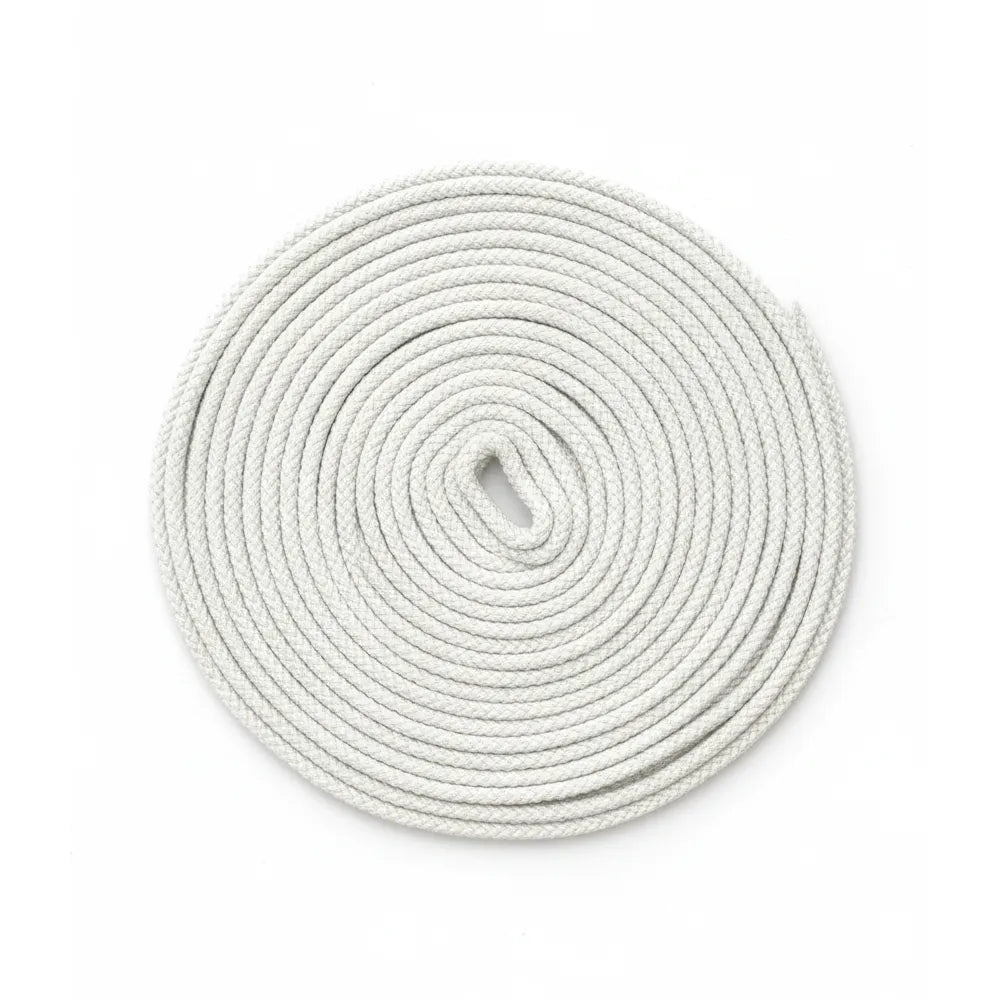 Coiled white flagpole rope on a white background