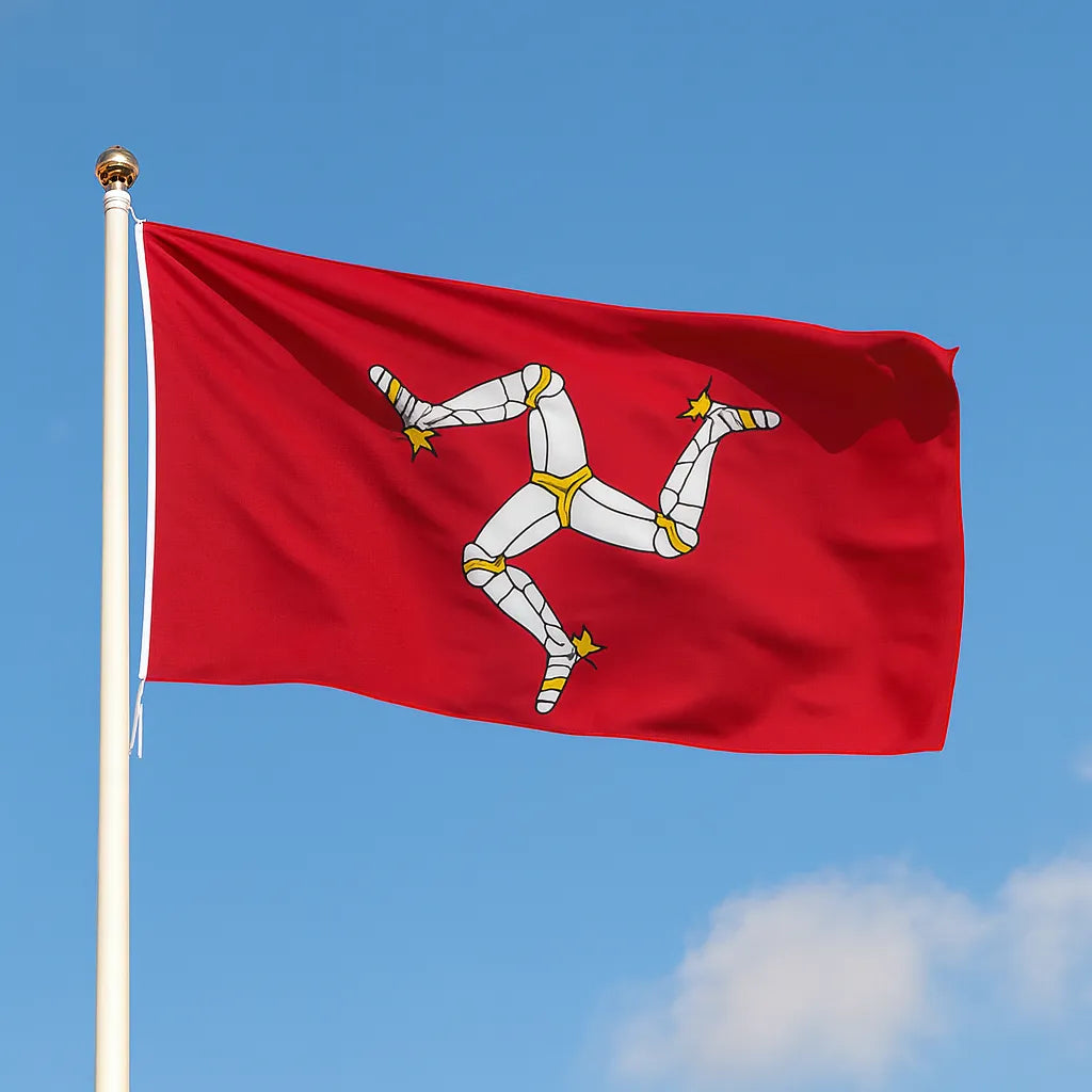 Isle of man flag flying on a flagpole with a blue sky