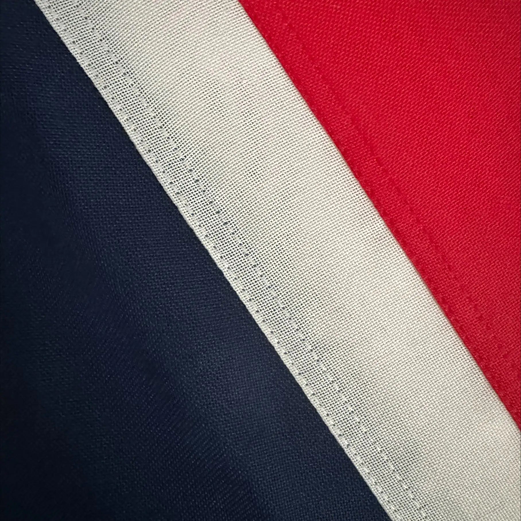 Close-up of a Sewn Union Jack Flag with a white stripe on a red and navy background