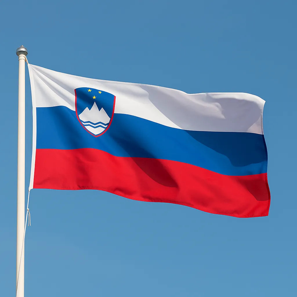 Slovenian flag waving against a clear blue sky