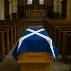 Casket draped with a blue and white cross flag in a church setting