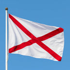 Flag with red cross on white background against a clear blue sky