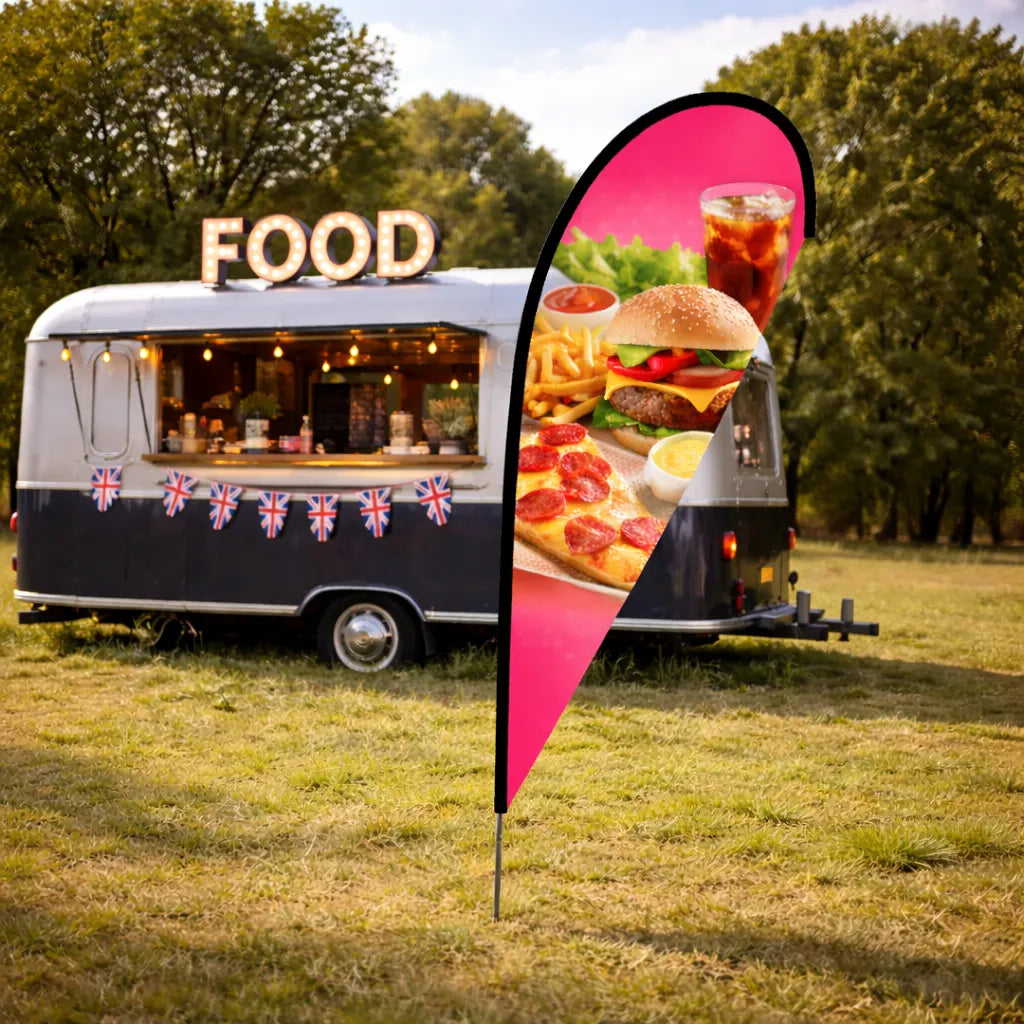 A tear drop shaped flag at an event